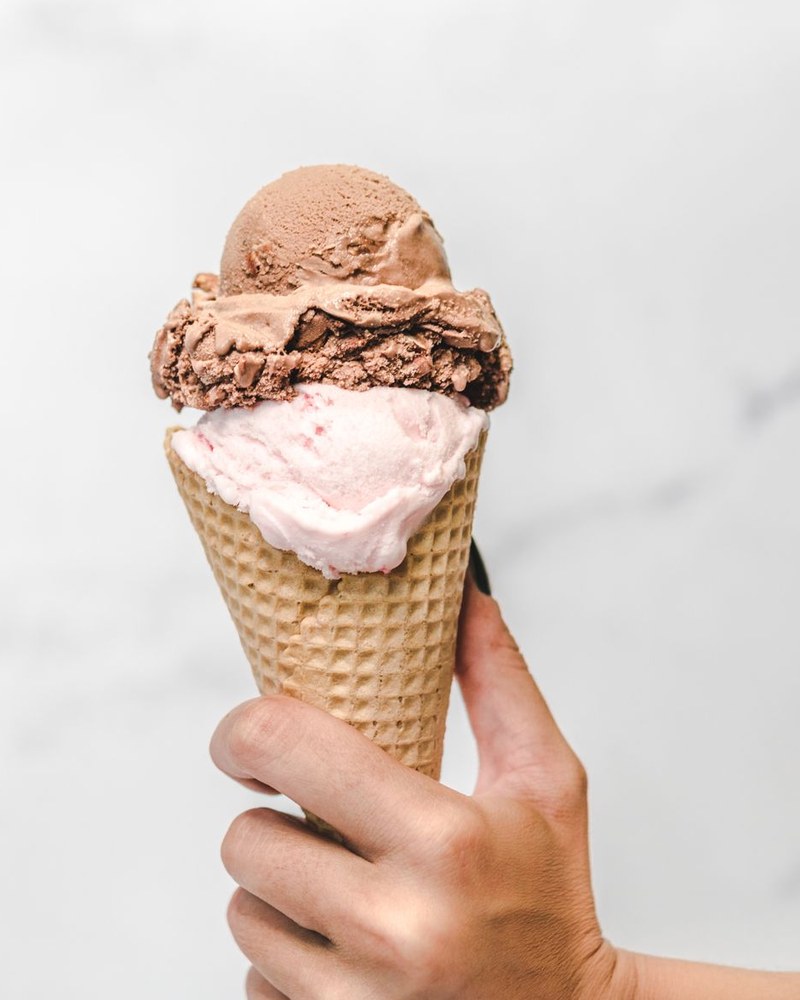 An ice cream cone stacked with two scoops.